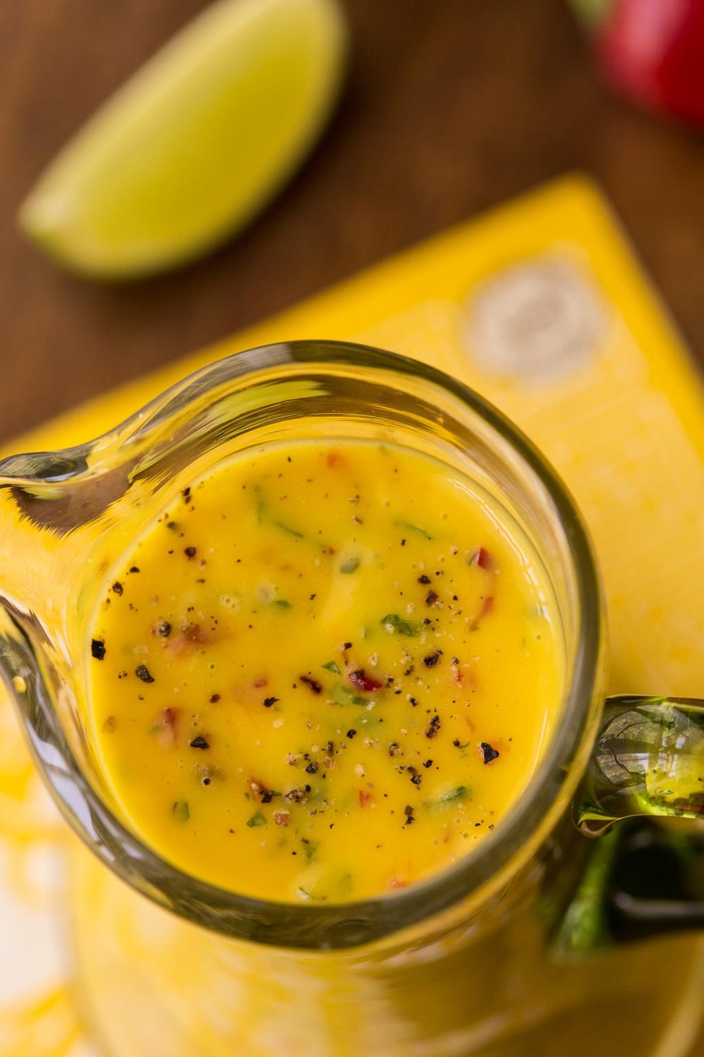 Overhead closeup photo of a glass carafe of Sweet and Spicy Mango Salad Dressing.