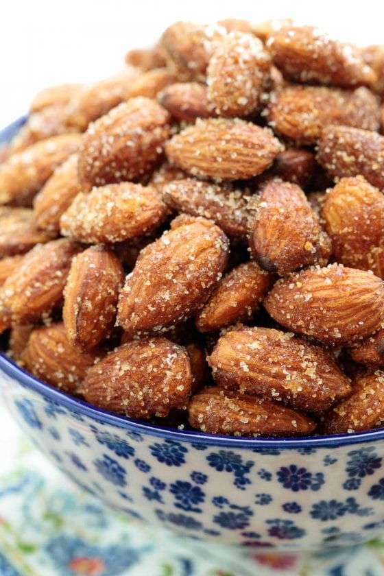 Closeup photo of a blue and white patterned dish filled with Sweet and Spicy Roasted Almonds.