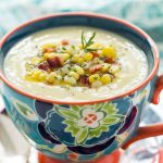 Vertical closeup photo of Fresh Corn Soup in a decorative flowered mug.