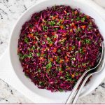 Overhead photo of a white bowl of Asian Red Cabbage Slaw.