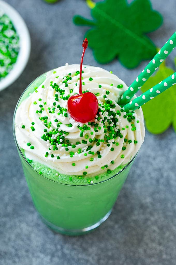 Overhead photo of a Shamrock Shake with whipped cream and sprinkles from Dinner at the Zoo food blog.