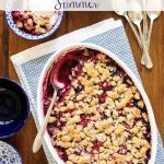 Overhead vertical photo of a Summer Berry Crisp in an oval white baking pan.