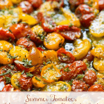 Extreme vertical closeup photo of a pan of slow roasted tomatoes.